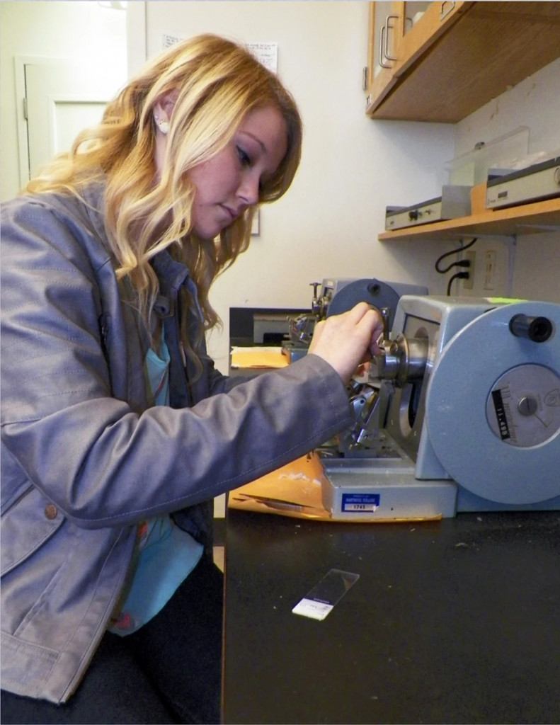 alumni briana goggin using a centrifuge at the hartwock college