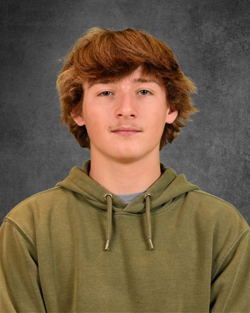 student, Nathan Fullem, posing for student picture day, wearing green hoodie