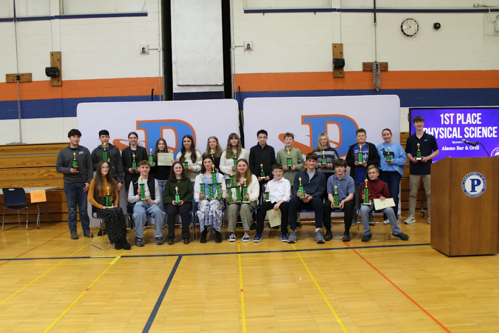 students standing/sitting for a group photo for the 38th Annual Science Fair
