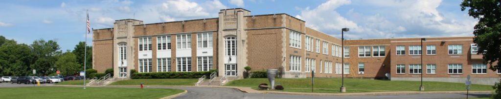 exterior of a large brick and cement building.