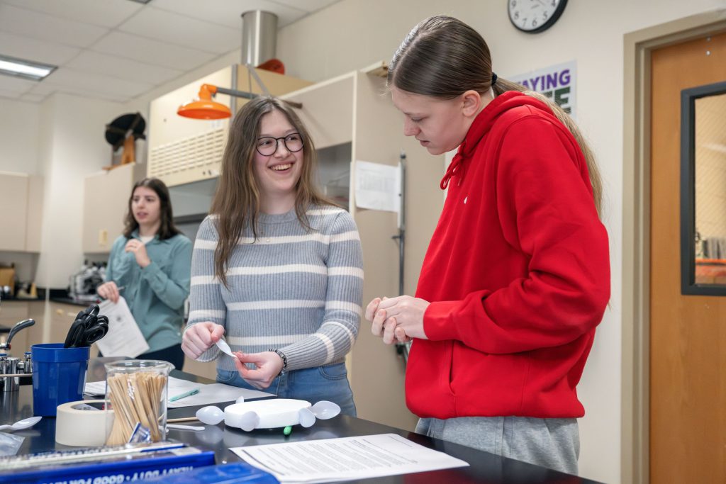 two students investigating lab tools together