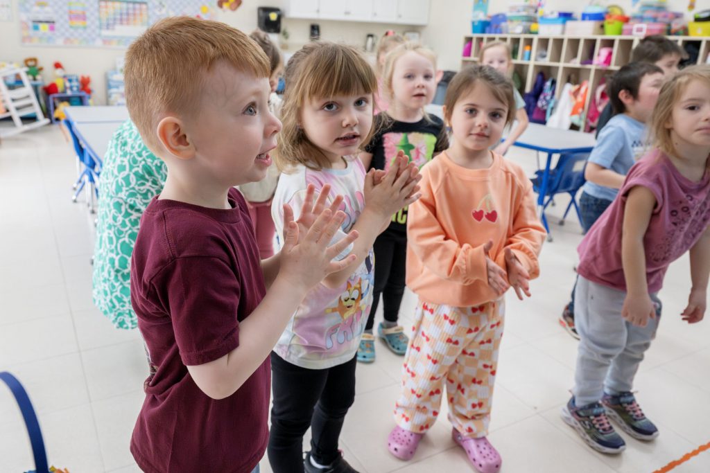 kids in class clapping together