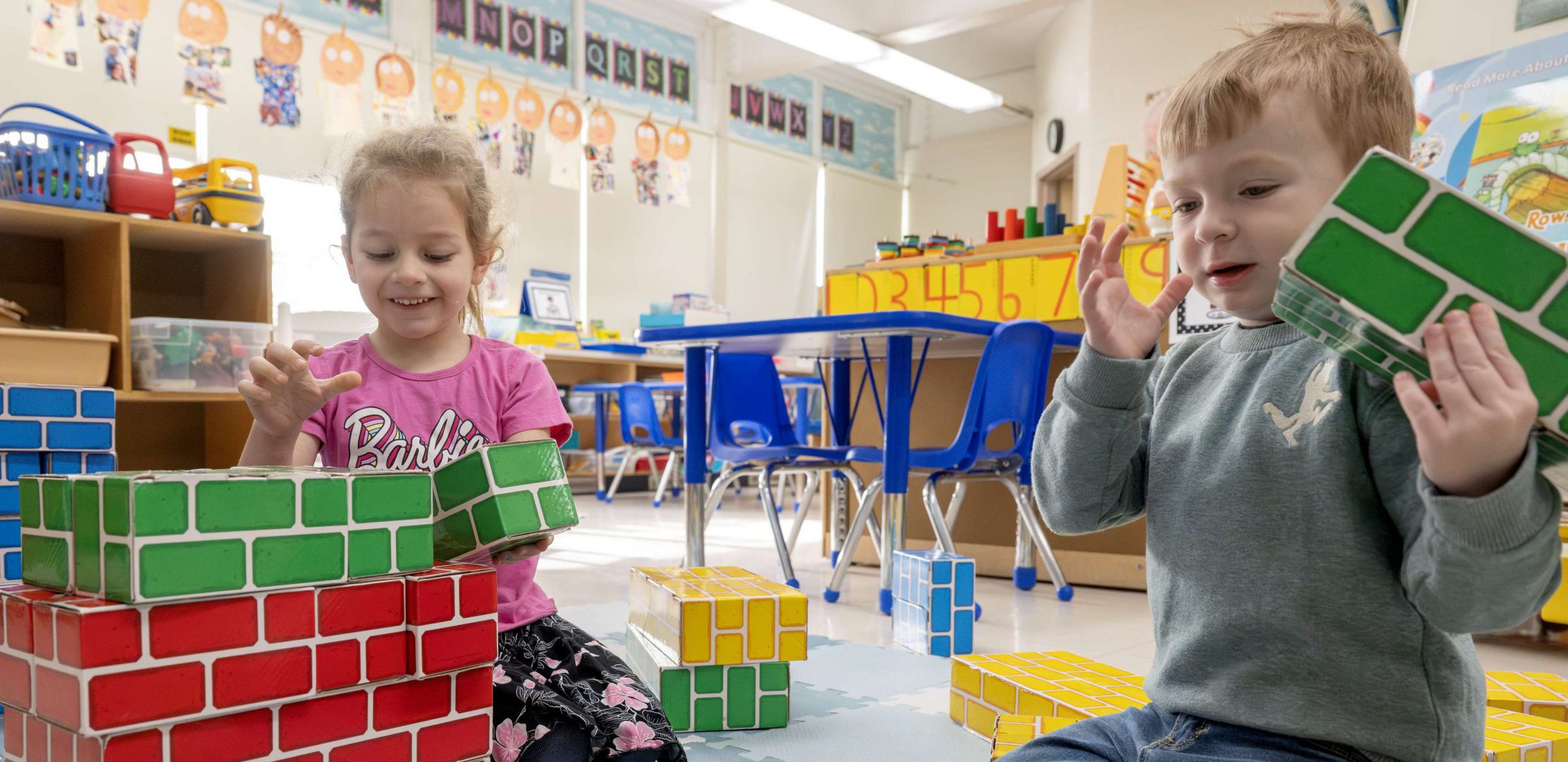 Students building blocks together