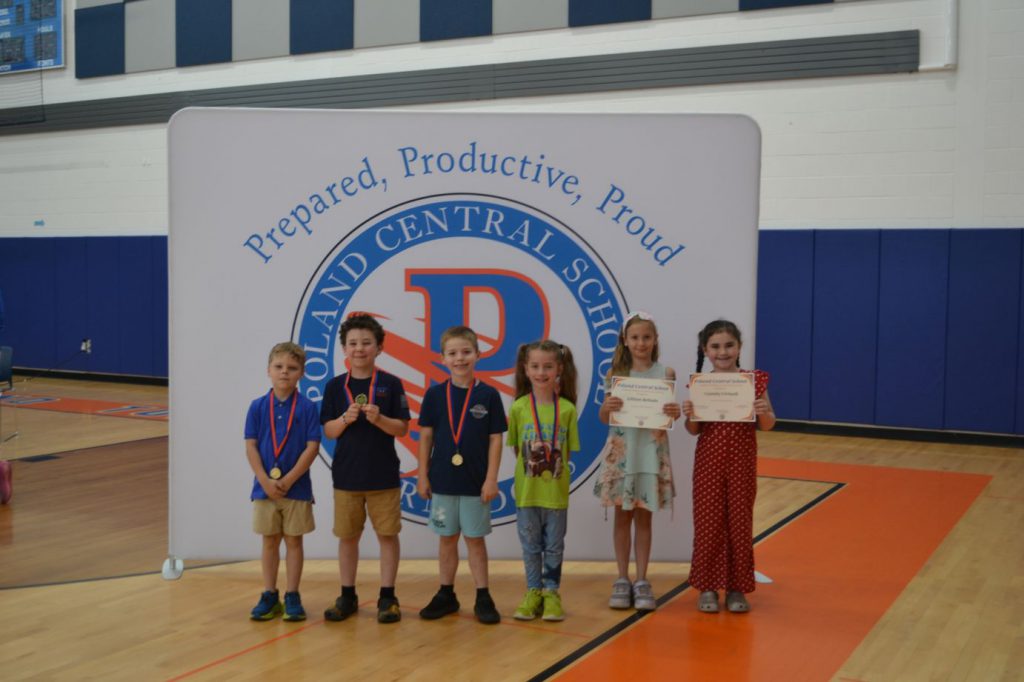 students smiling with awards