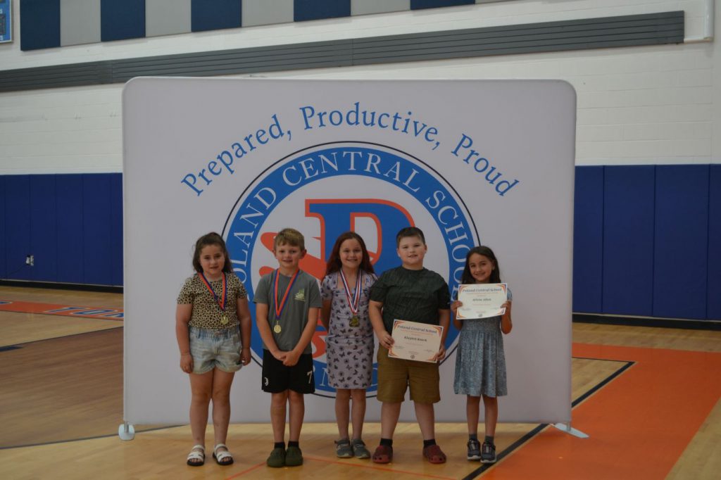 students smiling with awards