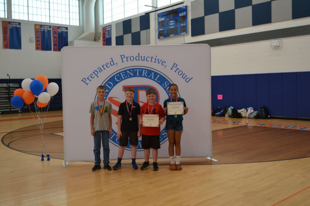 students smiling with awards