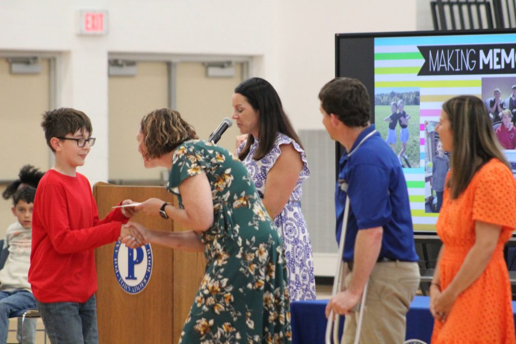 teacher shaking hand with student