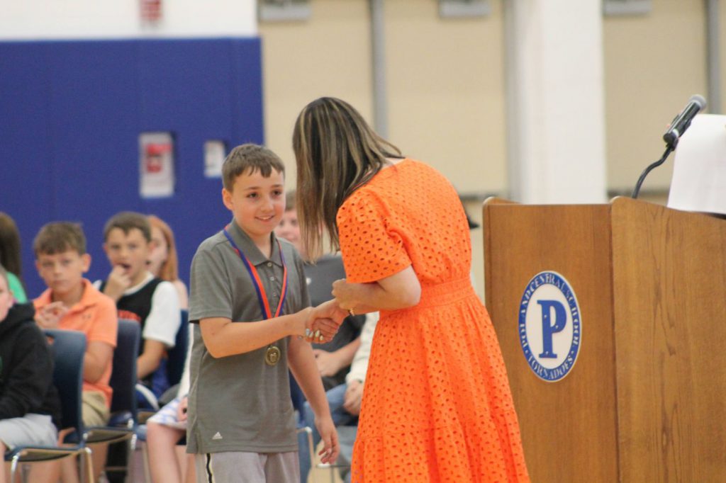 teacher shaking student's hands