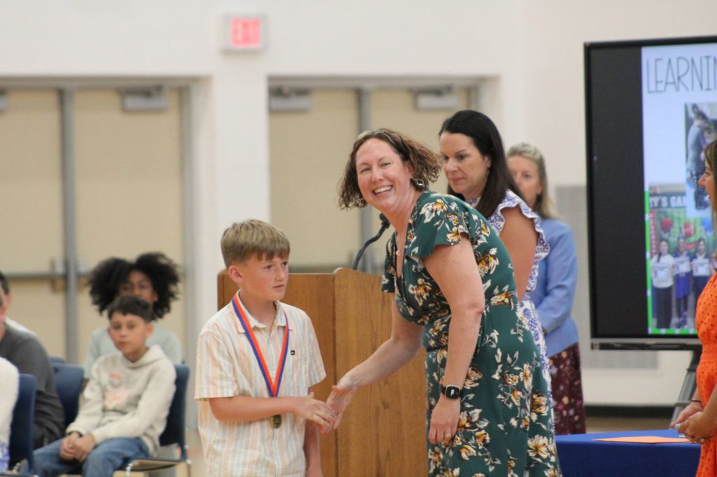 Teacher shaking hand with student
